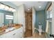 Nicely appointed bathroom features granite counters, vanity, and tile shower at 9325 Crugar Ter, Englewood, FL 34224