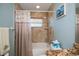 Nicely designed bathroom with tiled shower with seashell curtain and granite vanity top at 9325 Crugar Ter, Englewood, FL 34224