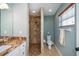 Nicely appointed bathroom with granite counters, tile shower, and bright light at 9325 Crugar Ter, Englewood, FL 34224