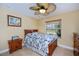 Bright bedroom showcasing a ceiling fan, neutral paint, and tile floors at 9325 Crugar Ter, Englewood, FL 34224