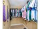 Walk in closet with built in shelves and hanging rods at 9325 Crugar Ter, Englewood, FL 34224