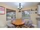 Cozy dining area with a round wooden table and views of the outdoors at 9325 Crugar Ter, Englewood, FL 34224