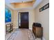 Elegant entryway with dark wood door, tile flooring, and decorative wall art at 9325 Crugar Ter, Englewood, FL 34224