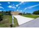 Charming home with a lengthy driveway leading to an attached two-car garage at 9325 Crugar Ter, Englewood, FL 34224