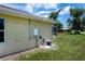 Exterior shot of utilities, a back wall, and the corner of a screened-in pool at 9325 Crugar Ter, Englewood, FL 34224