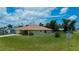Lovely single-story home featuring a well-manicured lawn and tasteful landscaping at 9325 Crugar Ter, Englewood, FL 34224