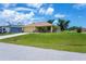 Single-story home with manicured lawn, showcasing its well-maintained exterior and curb appeal at 9325 Crugar Ter, Englewood, FL 34224
