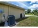 Exterior shot of the side of a house with air conditioning unit and hose at 9325 Crugar Ter, Englewood, FL 34224