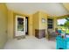 Comfortable front porch featuring seating, decor, and a welcoming entrance at 9325 Crugar Ter, Englewood, FL 34224