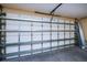 Spacious garage interior featuring ample storage shelving and a clean, well-maintained appearance at 9325 Crugar Ter, Englewood, FL 34224