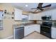Updated kitchen featuring modern stainless steel appliances, granite counters and white cabinetry at 9325 Crugar Ter, Englewood, FL 34224