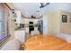 Bright kitchen featuring white cabinets and stainless steel appliances, adjacent to dining area at 9325 Crugar Ter, Englewood, FL 34224