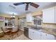 Eat-in kitchen features granite countertops, stainless appliances, white cabinetry and view to the outdoors at 9325 Crugar Ter, Englewood, FL 34224