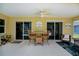 Relaxing covered lanai with ceiling fan and comfortable seating area at 9325 Crugar Ter, Englewood, FL 34224