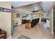 Spacious living room featuring tray ceilings, tile floors, and comfortable seating area at 9325 Crugar Ter, Englewood, FL 34224