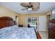Bedroom with tile floors, ceiling fan and view to the pool at 9325 Crugar Ter, Englewood, FL 34224