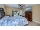 Bright primary bedroom offers view of the pool, tile floors, fan, and closet at 9325 Crugar Ter, Englewood, FL 34224