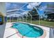 Enclosed pool with a clear blue water, and expansive views of the lush surrounding greenery at 9325 Crugar Ter, Englewood, FL 34224