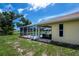 View from inside of the screen enclosed pool, with sliding glass doors leading to the house at 9325 Crugar Ter, Englewood, FL 34224