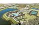 Aerial view of community amenities featuring a pool, tennis courts, and scenic walking trails by the lake at 10258 Morning Mist Ln, Sarasota, FL 34241