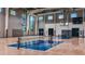 Well-lit indoor basketball court with modern hoops, ideal for residents to engage in sports at 10258 Morning Mist Ln, Sarasota, FL 34241