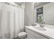 Clean bathroom featuring a single sink, toilet, and a shower with a curtain, all in white at 10258 Morning Mist Ln, Sarasota, FL 34241