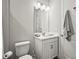 Bright bathroom featuring a white vanity, toilet, and neutral wall color at 10258 Morning Mist Ln, Sarasota, FL 34241