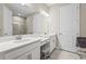 Bright bathroom featuring dual sinks, vanity area, and a separate glass-enclosed shower at 10258 Morning Mist Ln, Sarasota, FL 34241