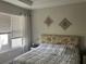 Inviting bedroom with a comfortable bed, patterned headboard, and bright window at 10258 Morning Mist Ln, Sarasota, FL 34241