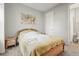 Bright bedroom with bedside table and ensuite bathroom featuring a comfortable bed and neutral decor at 10258 Morning Mist Ln, Sarasota, FL 34241