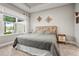 Comfortable bedroom features a patterned headboard and a window view of the serene outdoors at 10258 Morning Mist Ln, Sarasota, FL 34241
