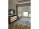 Cozy bedroom with a large window, a dresser, and a comfortable-looking bed at 10258 Morning Mist Ln, Sarasota, FL 34241