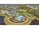 Overhead view features a community pool, pickleball courts, and lush landscaping at 10258 Morning Mist Ln, Sarasota, FL 34241