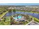 Aerial view of the resort-style community pool, bocce ball court, and lush landscaping at 10258 Morning Mist Ln, Sarasota, FL 34241