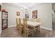Elegant dining room featuring a tray ceiling, decorative artwork, and stylish display cases at 10258 Morning Mist Ln, Sarasota, FL 34241