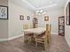 Formal dining room featuring a tray ceiling, stylish light fixture, and display cabinets at 10258 Morning Mist Ln, Sarasota, FL 34241