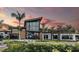 Modern building exterior with large windows and elegant landscaping, showcasing community architecture at 10258 Morning Mist Ln, Sarasota, FL 34241
