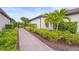Villa exterior showing a brick pathway, decorative plants, manicured lawn and tile roof at 10258 Morning Mist Ln, Sarasota, FL 34241