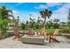 Outdoor firepit area with comfortable seating and well-manicured landscaping at 10258 Morning Mist Ln, Sarasota, FL 34241