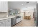 Bright kitchen with stainless steel appliances that opens up to the living and dining room areas at 10258 Morning Mist Ln, Sarasota, FL 34241