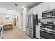 Well-lit kitchen featuring stainless steel appliances and seamless access to the dining room at 10258 Morning Mist Ln, Sarasota, FL 34241