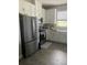 Well-lit kitchen featuring stainless steel appliances, white cabinetry, and tile flooring at 10258 Morning Mist Ln, Sarasota, FL 34241