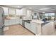 Bright kitchen with white cabinetry, stainless steel appliances, and a view of the living room and backyard at 10258 Morning Mist Ln, Sarasota, FL 34241