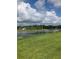 Scenic lake view with lush green grass in a beautiful community at 10258 Morning Mist Ln, Sarasota, FL 34241