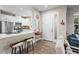 Welcoming living room featuring bar seating, stainless steel appliances, and access to the front door at 10258 Morning Mist Ln, Sarasota, FL 34241
