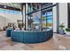 Stylish lobby with curved seating, a cozy fireplace, a large screen TV and luxurious tile floors at 10258 Morning Mist Ln, Sarasota, FL 34241
