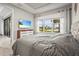 Main bedroom with pond view, complemented by a TV and stylish dresser, offering a peaceful retreat at 10258 Morning Mist Ln, Sarasota, FL 34241