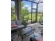 Inviting screened-in patio seating area with comfortable furniture and views of lush landscape at 10258 Morning Mist Ln, Sarasota, FL 34241