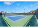 Community pickleball courts with lush landscaping and shaded seating areas at 10258 Morning Mist Ln, Sarasota, FL 34241