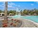 Resort-style pool with a fun water slide feature and surrounding lounge area for relaxation on a sunny day at 10258 Morning Mist Ln, Sarasota, FL 34241